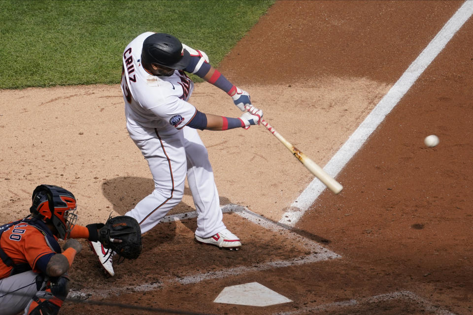 Minnesota Twins' Nelson Cruz hits an RBI double off Houston Astros pitcher Zack Greinke in the third inning of an American League wild-card series baseball game, Tuesday Sept. 29, 2020, in Minneapolis. (AP Photo/Jim Mone)