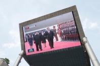 A television screen shows Chinese state media CCTV's footage of North Korean leader Kim Jong Un's meeting with Chinese President Xi Jinping in Pyongyang, in Beijing