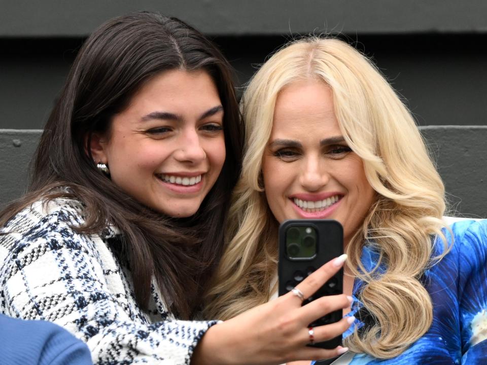 Rebel Wilson, right, takes a selfie with a fellow spectator at Wimbledon day two.