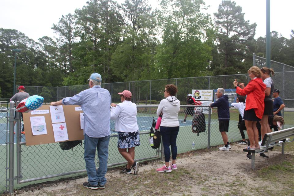 Spectators watch a pickleball game between players Wayne Bigg, Dean Matt, Wilmington City Council member Clifford Barnett and Jimmy Santangelo at Northern Regional Park in Castle Hayne on Thursday. Matt is attempting to play a game of pickleball in each of the 48 contiguous U.S. states within a span of 26 days.
