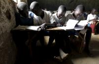 Students attend a class session at the Senator Obama primary school near ancestral home of U.S. President Barack Obama in Nyangoma village in Kogelo, west of Kenya's capital Nairobi, June 23, 2015. When Barack Obama visits Africa this month, he will be welcomed by a continent that had expected closer attention from a man they claim as their son, a sentiment felt acutely in the Kenyan village where the 44th U.S. president's father is buried. Picture taken June 23, 2015. (REUTERS/Thomas Mukoya)