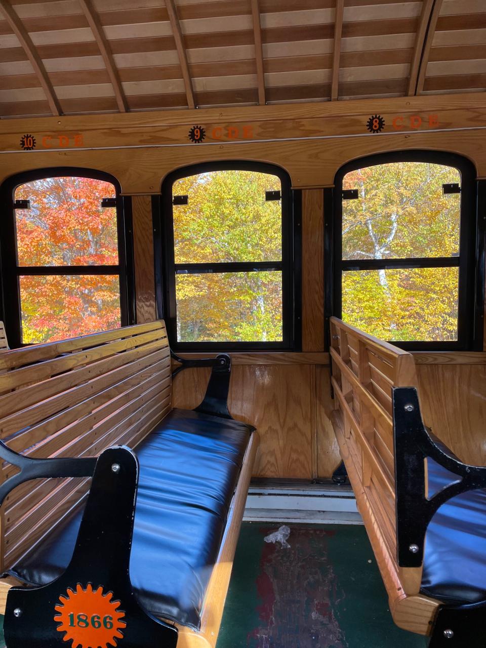 Wooden benches tilted downward on a train