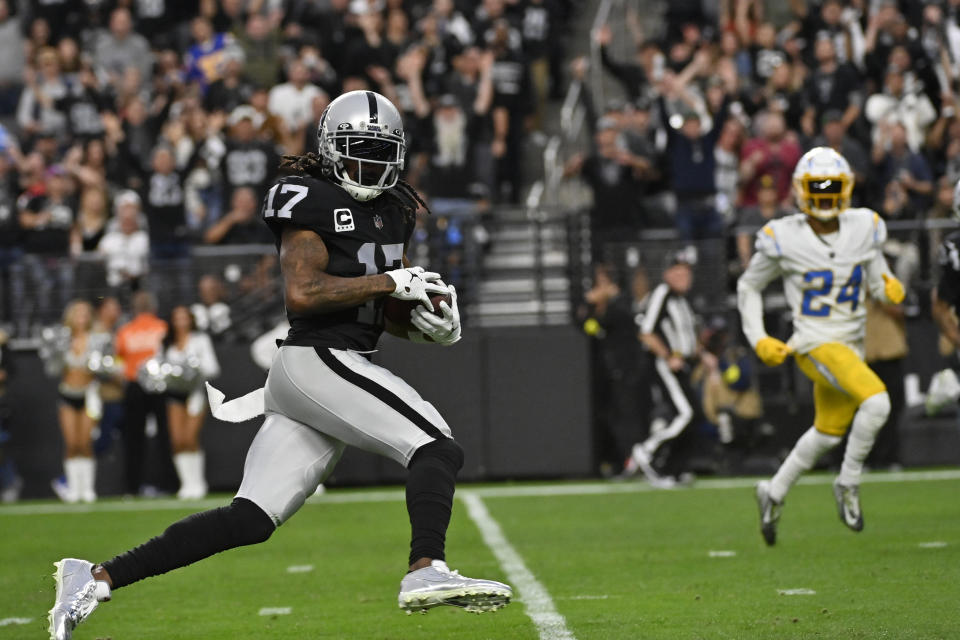 Las Vegas Raiders wide receiver Davante Adams (17) carries on a touchdown reception during the second half of an NFL football game against the Los Angeles Chargers, Sunday, Dec. 4, 2022, in Las Vegas. (AP Photo/David Becker)