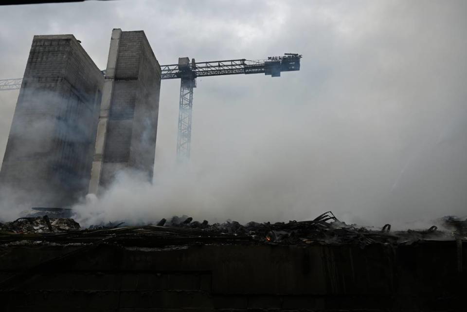 A crane and two elevators structures remain after a massive fire broke out at a construction scene in South Park. A pair of developers broke ground on an apartment project last year.