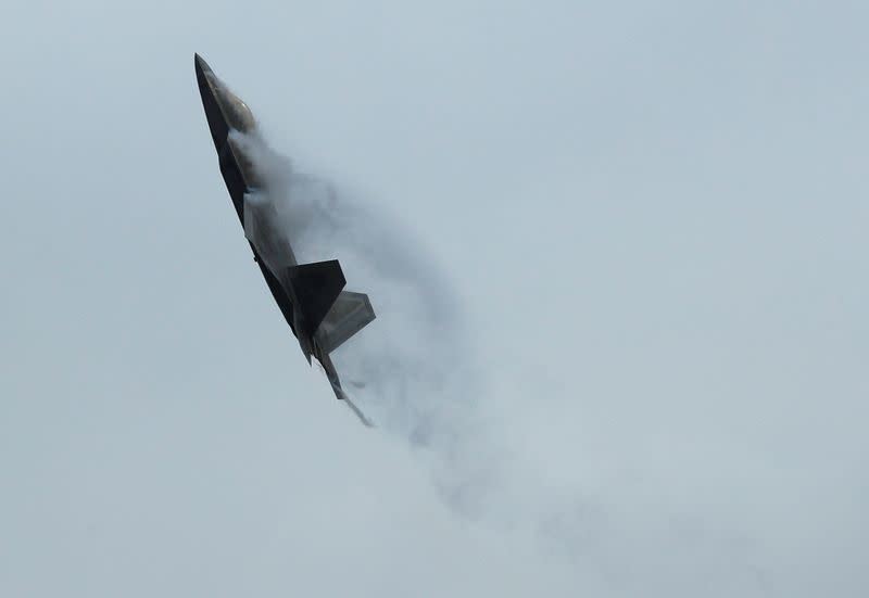 A U.S. Pacific Air Force F-22 Raptor performs an aerial display during a media preview of the Singapore Airshow in Singapore