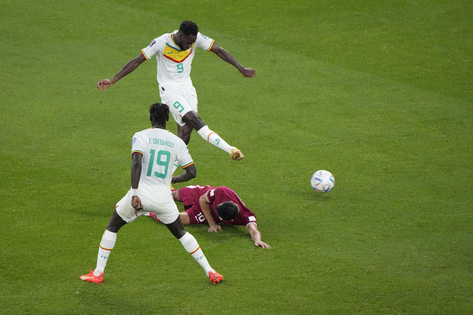 Senegal's Boulaye Dia shoots and scores a goal during the World Cup group A soccer match between Qatar and Senegal, at the Al Thumama Stadium in Doha, Qatar, Friday, Nov. 25, 2022. (AP Photo/Ariel Schalit)