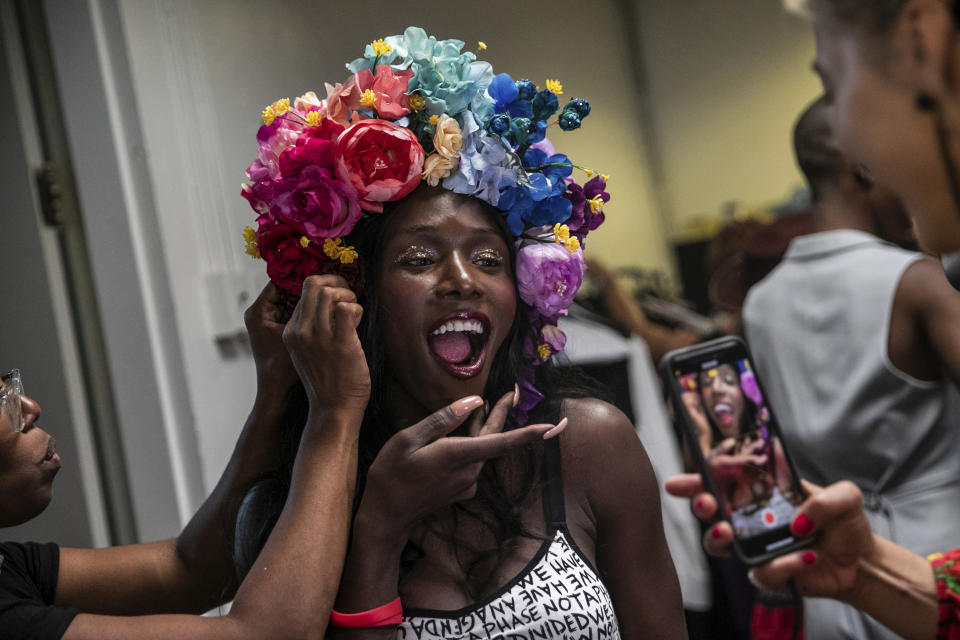 A makeup artist works on a model backstage at the dapperQ fashion show at the Brooklyn Museum on Thursday, Sept. 5, 2019, in New York. (AP Photo/Jeenah Moon)