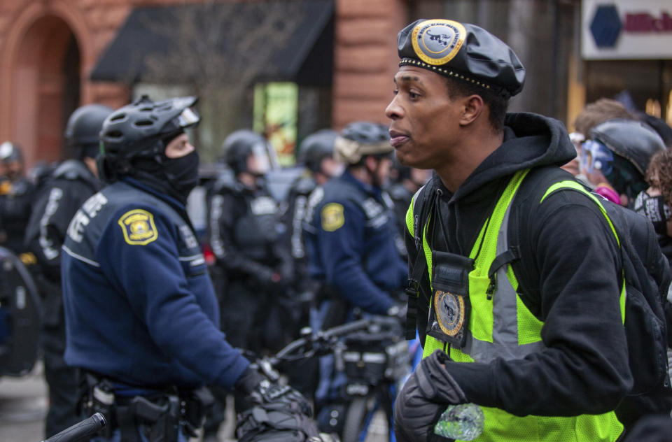 A member of the Royal Black Panter Party speaks to police as protesters march through downtown Grand Rapids, Mich., on Saturday, April 16, 2022. Activists have held protests for four straight days since the release of a video showing 26-year-old Congolese immigrant Patrick Lyoya being shot and killed by a Grand Rapids police officer while resisting arrest during a traffic stop on April 4. (Daniel Shular/The Grand Rapids Press via AP)