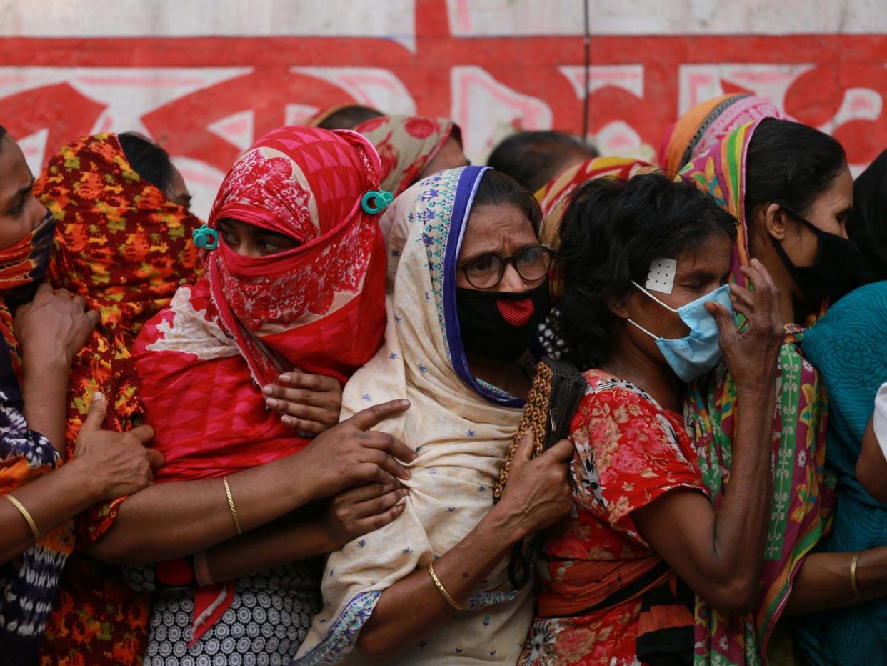 Poor people queue to collect aid during the nationwide lockdown as a preventive measure against the COVID-19 coronavirus outbreak in Dhaka, Bangladesh on 1 April 2020: Getty