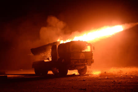 Popular Mobilization Forces (PMF) fire towards Islamic State militants during a battle in Qairawan, west of Mosul, Iraq May 23, 2017. REUTERS/Stringer