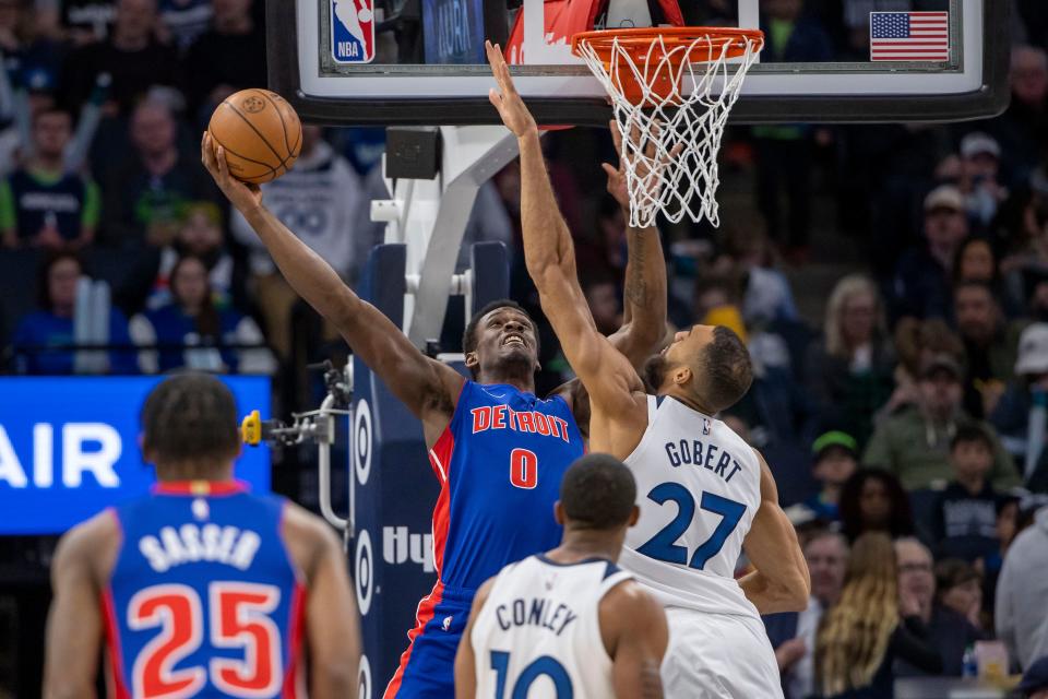 Detroit Pistons center Jalen Duren (0) drives to the basket and shoots the ball over Minnesota Timberwolves center Rudy Gobert (27) in the first half at Target Center in Minneapolis on Wednesday, March 27, 2024.