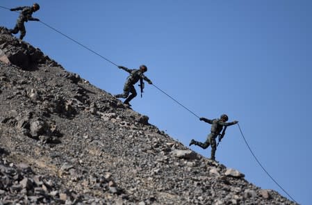 FILE PHOTO: Paramilitary police take part in a drill at an anti-terrorism military training base in Korla