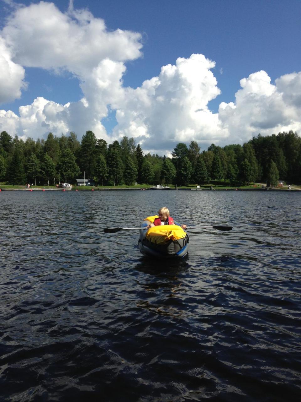 Oliver Russell kayaking on a lake in Finland.