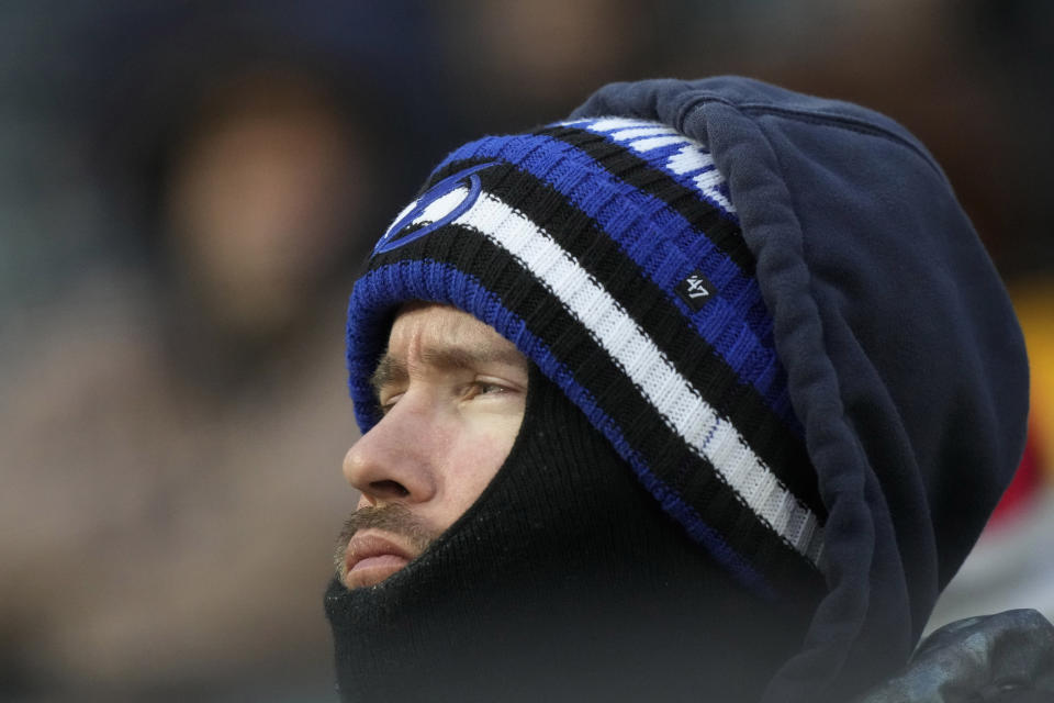 A baseball fan bundles up as he watches the first inning of a baseball game between the Atlanta Braves and the Chicago White Sox in Chicago, Tuesday, April 2, 2024. (AP Photo/Nam Y. Huh)