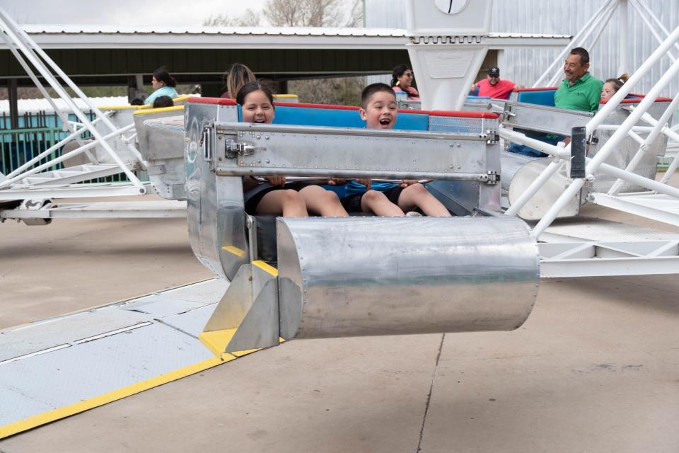 Two children enjoy the Scrambler at the Wonderland Amusement Park in Amarillo in this April 2023 file photo. The park opens for the season on Saturday, offering a holiday getaway over Easter weekend.