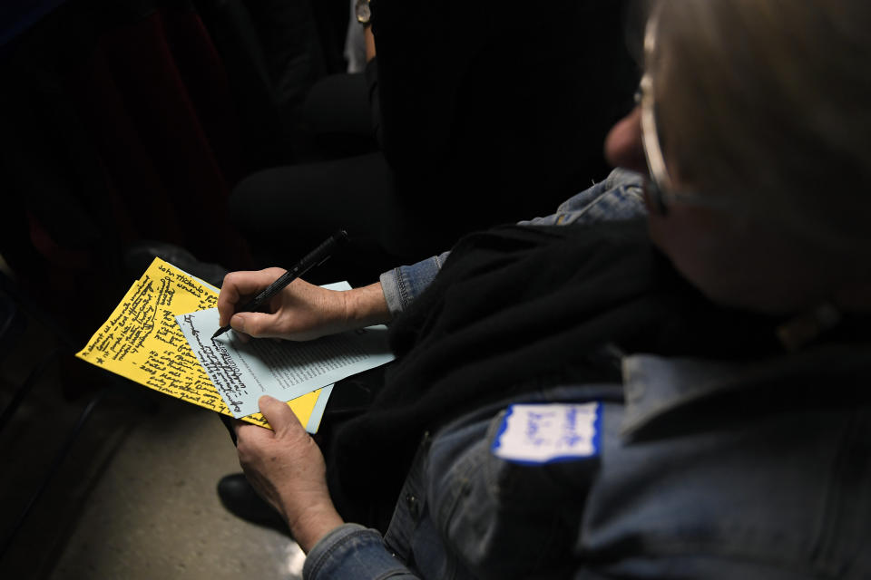 Ammertte Deibert, 70, of Ames, Iowa, jots down notes as she listens to Harris, former Colorado Gov. John Hickenlooper and former HUD Secretary Juli&aacute;n Castro&nbsp;at the Story County Democrats Soup Supper on Feb. 23. (Photo: Joe Amon/MediaNews Group/The Denver Post via Getty Images via Getty Images)