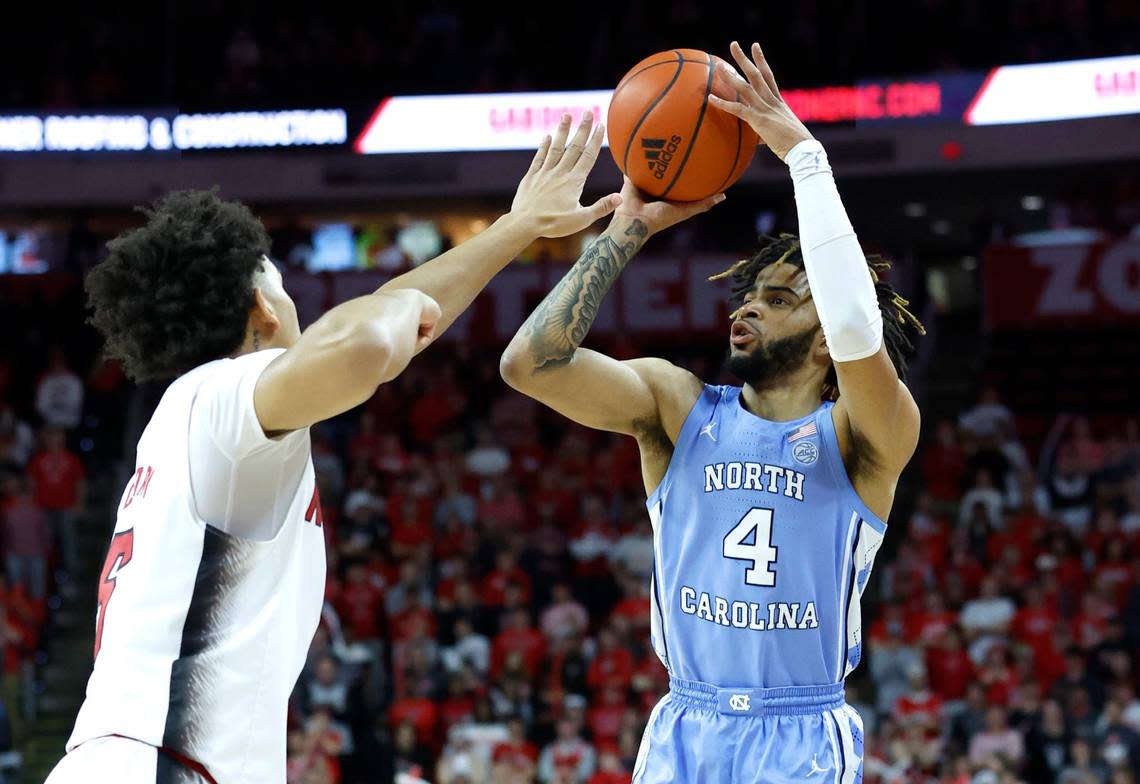 North Carolina’s R.J. Davis (4) shoots as N.C. State’s Jack Clark (5) defends during the first half of N.C. State’s game against UNC at PNC Arena in Raleigh, N.C., Sunday, Feb. 19, 2023.