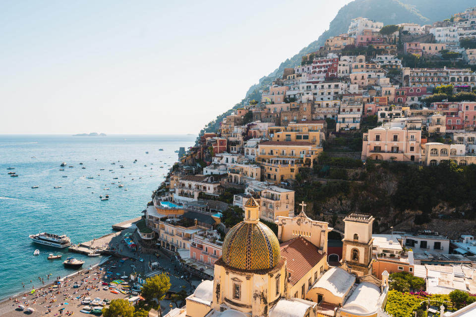 Colorful buildings stacked on a hillside overlooking the ocean