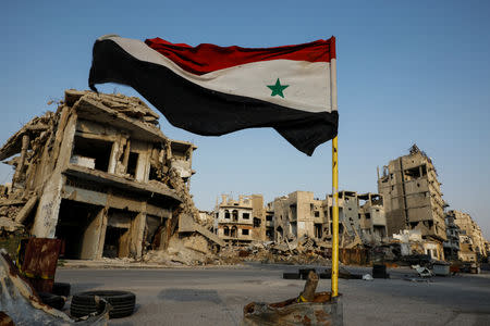 Syrian flag flutters at a military check point in al-Khalidiya area, in the government-controlled part of Homs, Syria, September 18, 2018. REUTERS/Marko Djurica/Files