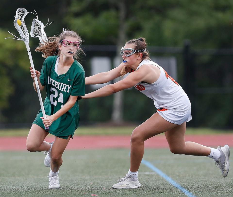 Duxbury's Mackenzie Kingston moves from behind the Wayland goal under pressure from Lily Cerne of Wayland.
Wayland defeats Duxbury girls lacrosse in MIAA tournament action in Weymouth on Wednesday June 14, 2023