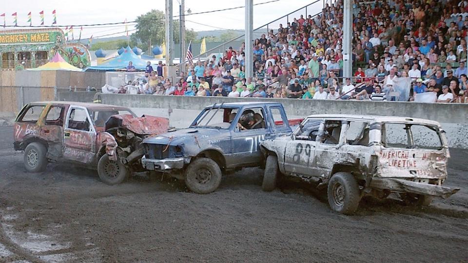 A Chevy Blazer, a Ford Ranger and a Jeep Cherokee mix it up at the Chemung County Fair Demolition Derby.
