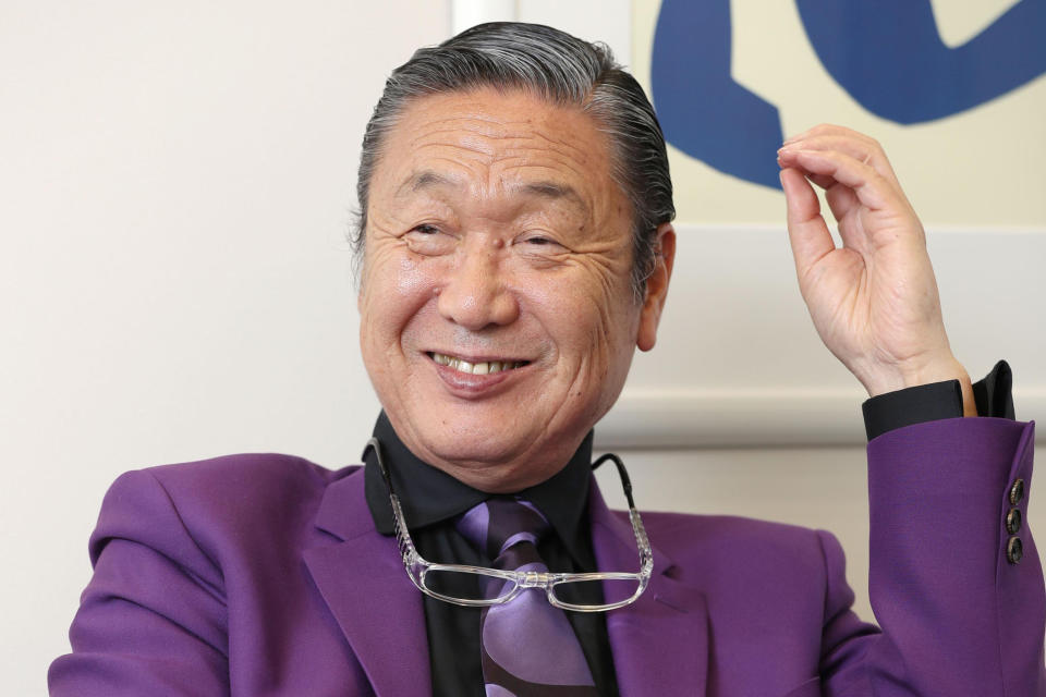 Japanese fashion designer Kansai Yamamoto speaks during an interview in Tokyo, in May, 2017. Yamamoto, known for his avant-garde and colorful work that included flamboyant costumes of the late rock icon David Bowie has died of leukemia, his company said on Monday, July 27, 2020. He was 76.(Kyodo News via AP)