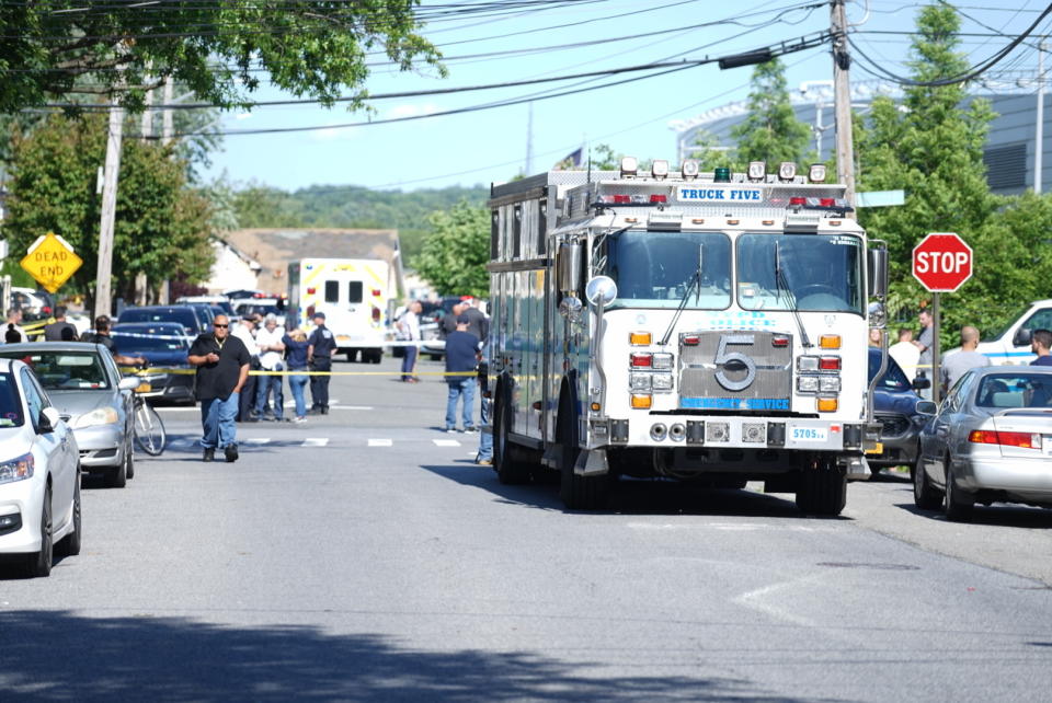 New York City Police officials gather along Wilcox Street behind the 121st Precinct station house following a report of a police officer shot in the Staten Island borough of New York, Friday, June 14, 2019. The officer's condition wasn't immediately known. (Joseph Ostapiuk/Staten Island Advance via AP)