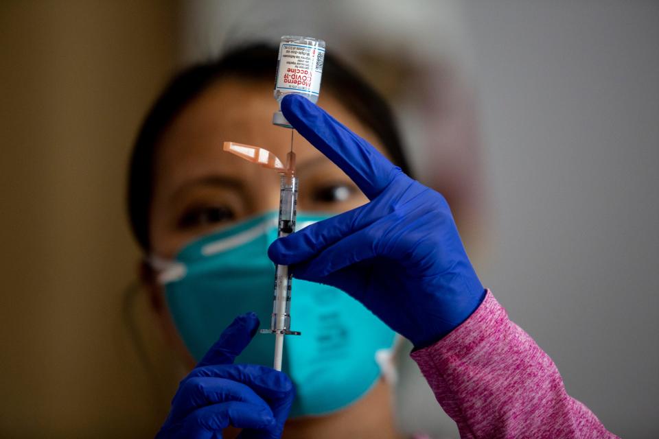 Desert Care Network pharmacist Pisey Long prepares second doses of the Moderna COVID-19 vaccine during a vaccination clinic at the Mizell Center in Palm Springs, Calif., on Feb. 27.