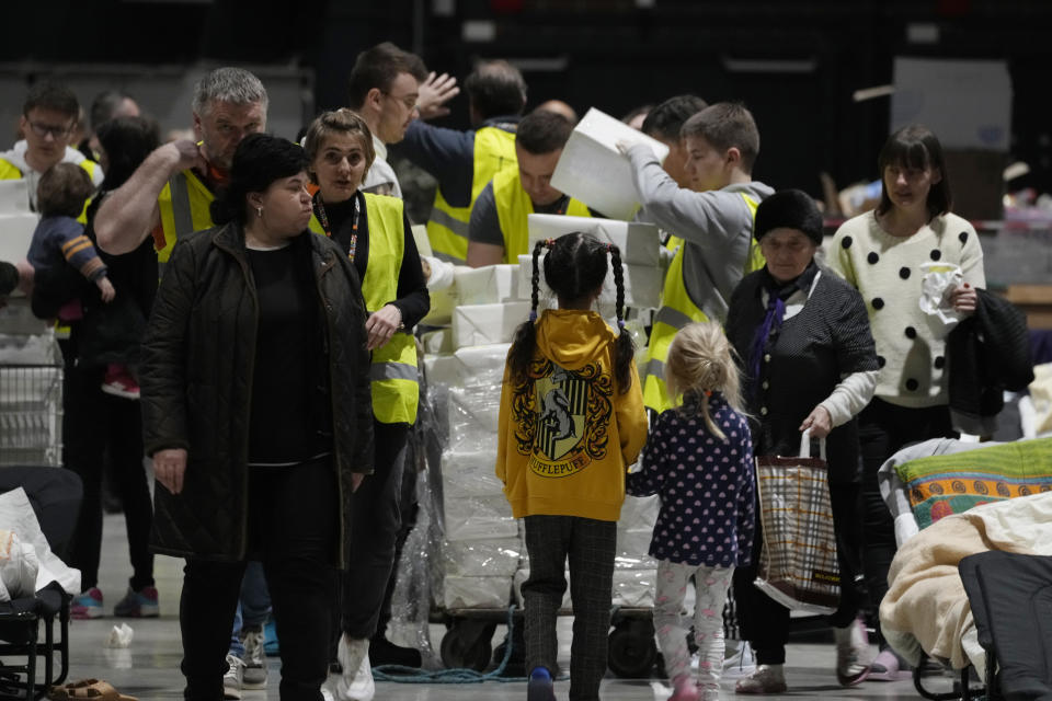 Volunteers distribute aid in a refugee center at the Global Expo in Warsaw, Poland, Saturday, April 2, 2022. (AP Photo/Czarek Sokolowski)