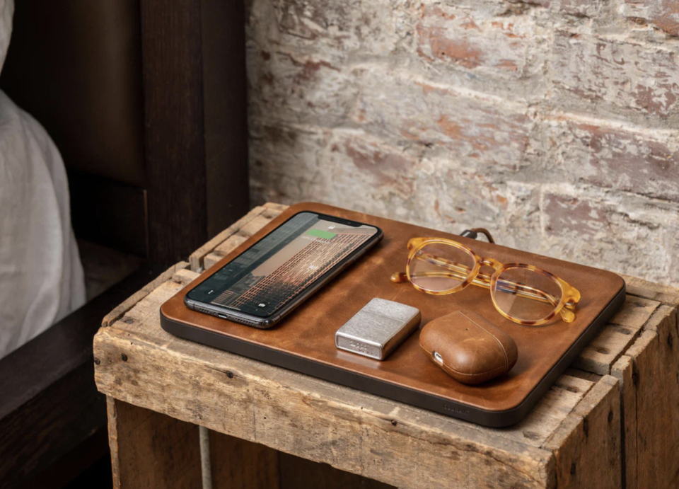 Courant Catch:3 Wireless Charger with phone, glasses, airpods on leather charging case (photo via Stay Courant)