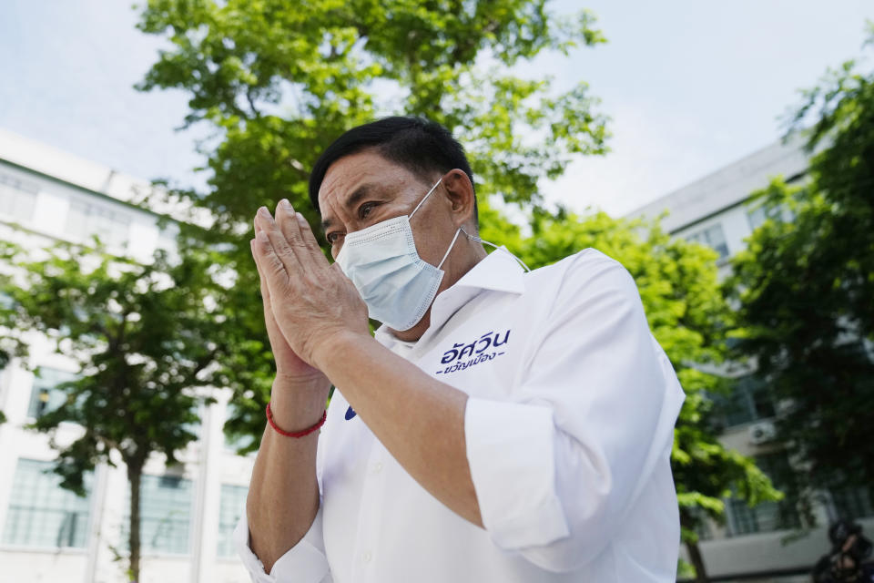 FILE - Bangkok governor independent candidate Asawin Kwanmuang prays to a Buddhist statue during an election campaign in Bangkok, Thailand, on May 17, 2022. Voters in Bangkok headed to the polls Sunday to elect a new governor, in a contest whose results are likely to be seen as a barometer of the public mood ahead of an approaching general election. A record-high 31 candidates entered the race, but the battle being watched most closely is between two who registered as independents: Chadchart Sittipunt and Asawin. (AP Photo/Sakchai Lalit, File)