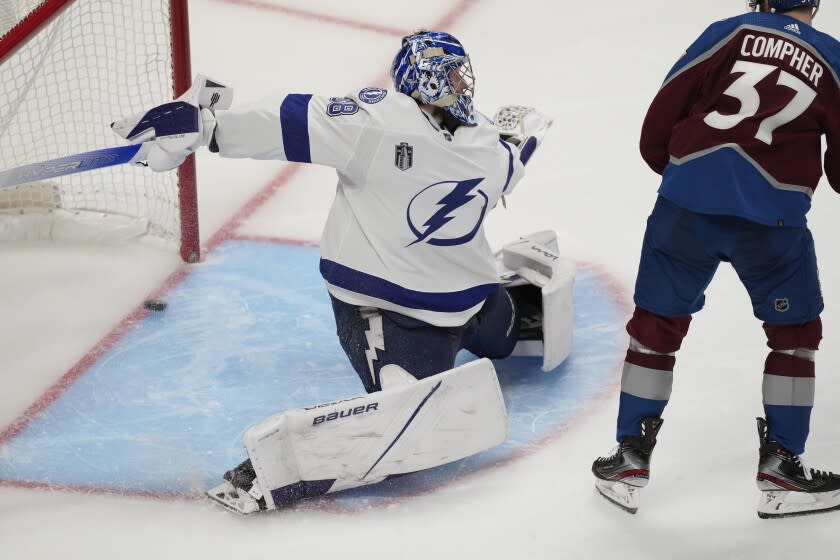 Tampa Bay Lightning goaltender Andrei Vasilevskiy gives up goal on a shot from Colorado Avalanche left wing Andre Burakovsky, not seen, during overtime in Game 1 of the NHL hockey Stanley Cup Final on Wednesday, June 15, 2022, in Denver. (AP Photo/David Zalubowski)