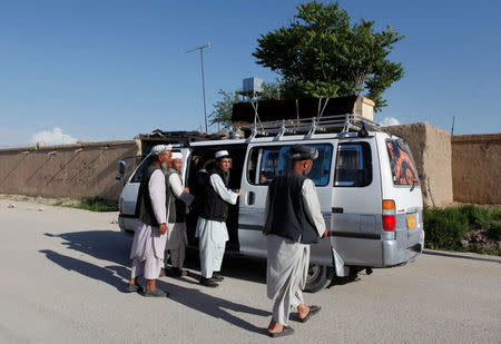 Relatives transport the coffin of one of the victims on top of a van a day after an attack on an army headquarters in Mazar-i-Sharif, northern Afghanistan April 22, 2017. REUTERS/Anil Usyan