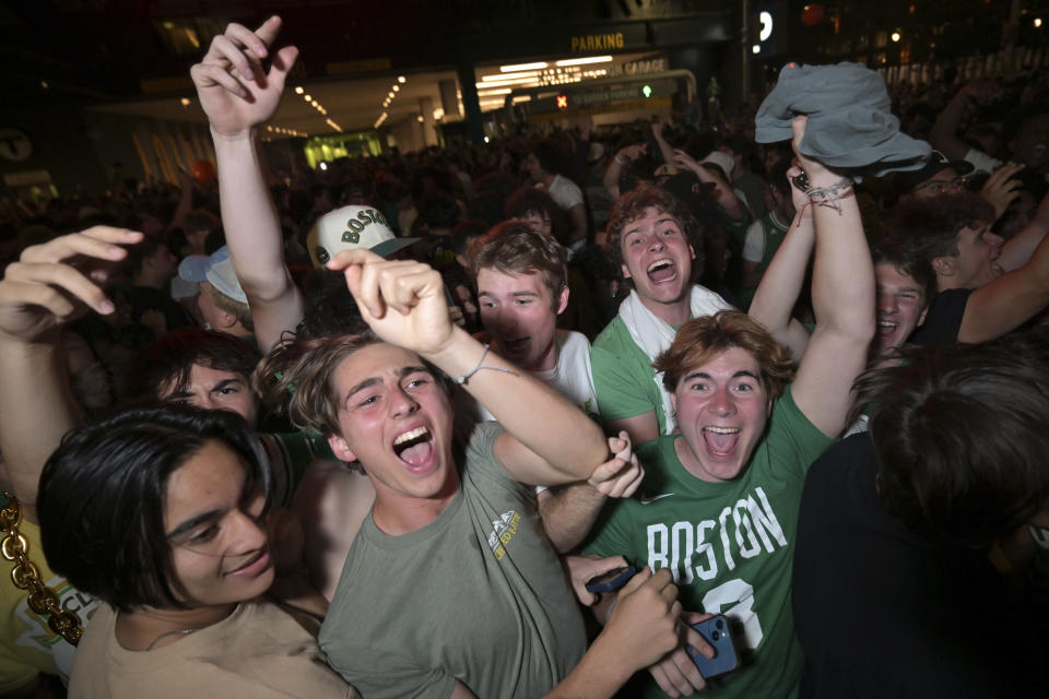 Boston Celtics fans react outside the TD Garden following the team's victory over the Dallas Mavericks in Game 5 of the NBA basketball finals in Boston Monday, June 17, 2024. (AP Photo/Josh Reynolds)