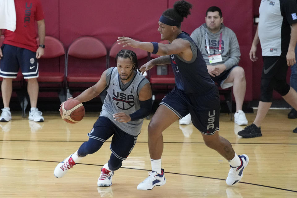 Jalen Brunson of the New York Knicks, left, drives against Paolo Banchero of the Orlando Magic during training camp for the United States men's basketball team Thursday, Aug. 3, 2023, in Las Vegas. (AP Photo/John Locher)