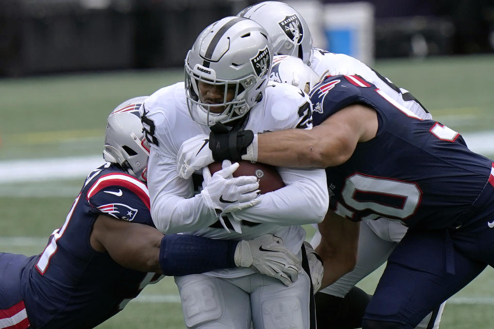 Las Vegas Raiders running back Josh Jacobs, center, runs with the ball against the New England Patriots in the first half of an NFL football game, Sunday, Sept. 27, 2020, in Foxborough, Mass. (AP Photo/Steven Senne)