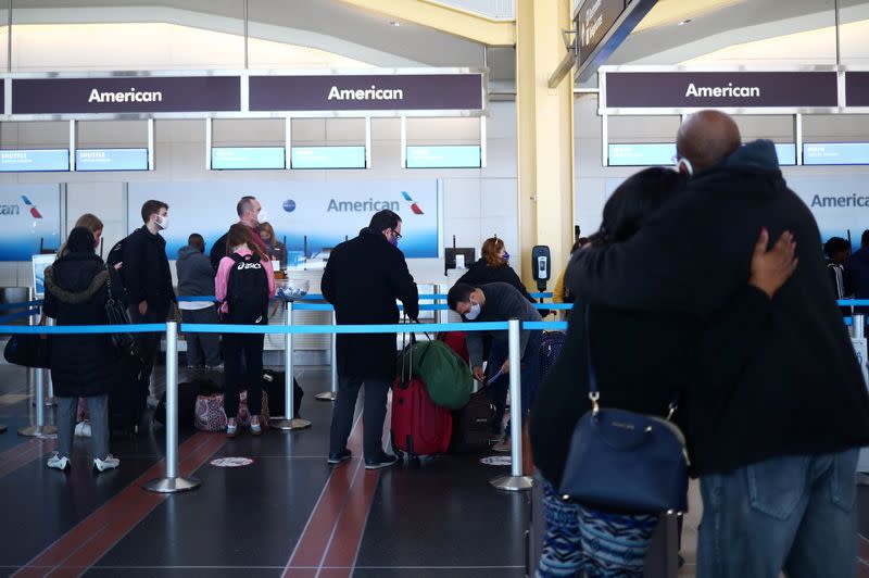 People queue at Reagan National Airport ahead of the Thanksgiving holiday in Arlington