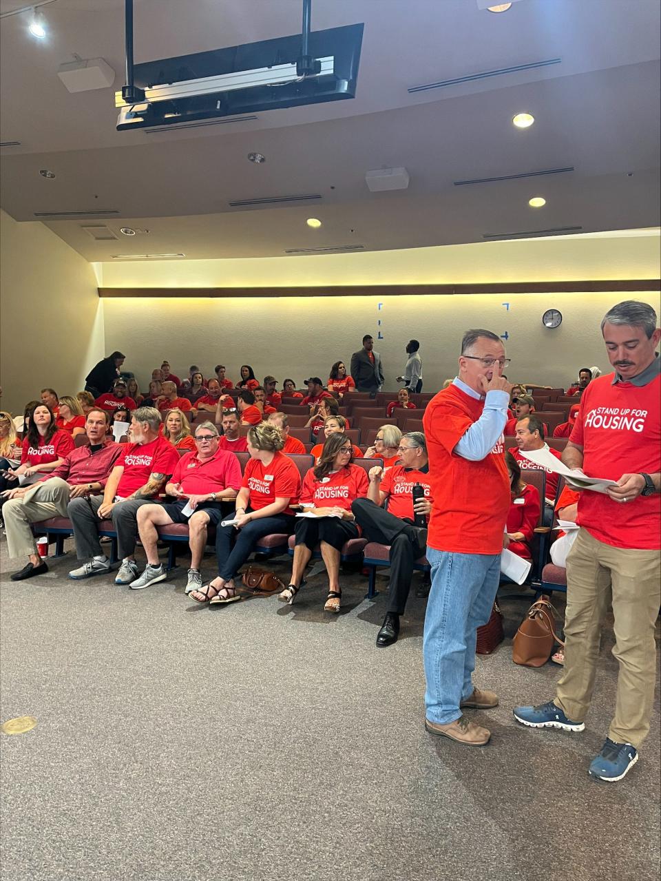 Dozens of members of the Homebuilders Association of West Florida attend the Santa Rosa County Commission meeting hall Monday, May 8, 2023, wearing "Stand Up For Housing" shirts. Members say some regulations and fees being contemplated as the county works to amend its Land Development Code are negatively impacting their occupation.