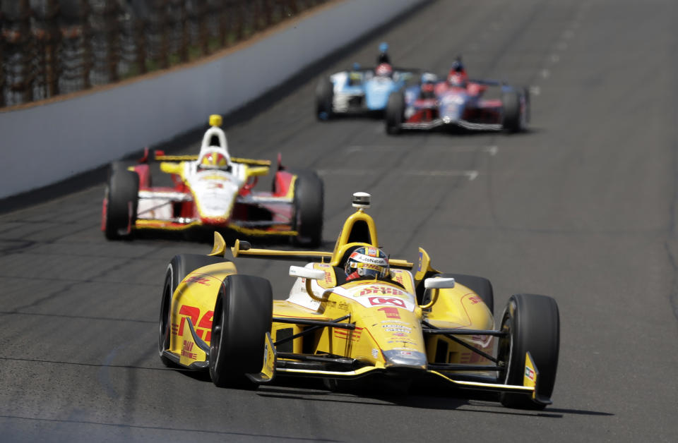 Ryan Hunter-Reay leads Helio Castroneves, of Brazil, into the first turn during a practice session on the second day of qualifications for the Indianapolis 500 auto race at the Indianapolis Motor Speedway in Indianapolis, Sunday, May 19, 2013. (AP Photo/Darron Cummings)