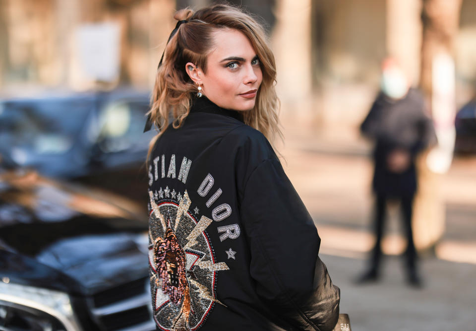 <p>Cara Delevingne shows off her street style outside of the Dior show during Paris Fashion Week on Jan. 24.</p>