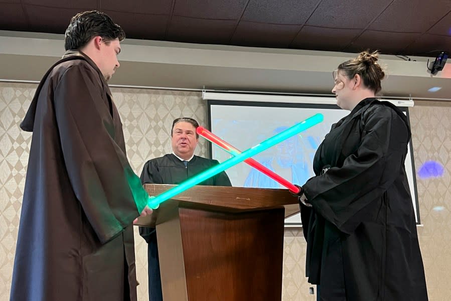 Julia and Robert Jones exchange vows during their wedding ceremony in Akron, Ohio, on Thursday, May 4, 2023. Couples celebrated May the Fourth with a "Star Wars" themed wedding. (AP Photo/Patrick Orsagos)