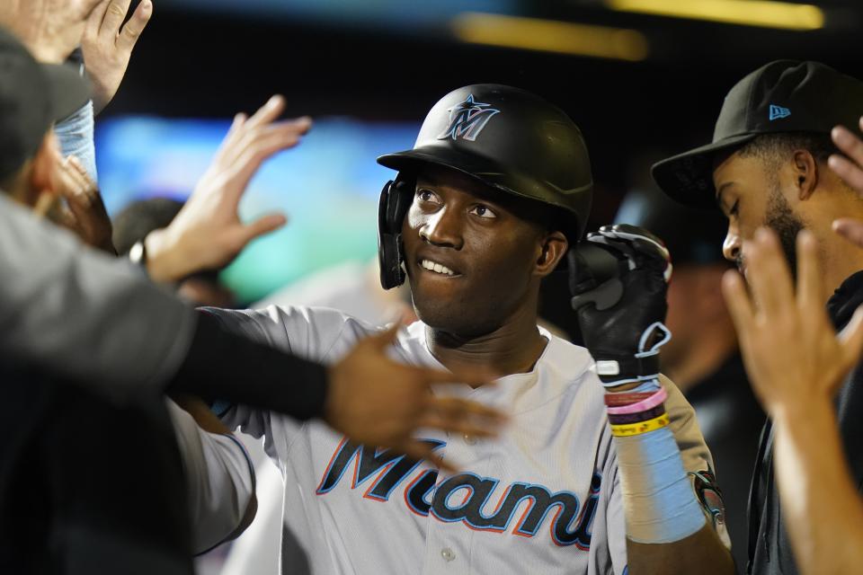 Miami Marlins' Jesus Sanchez celebrates with teammates after hitting a home run during the second inning in the second baseball game of a doubleheader against the New York Mets Tuesday, Sept. 28, 2021, in New York. (AP Photo/Frank Franklin II)