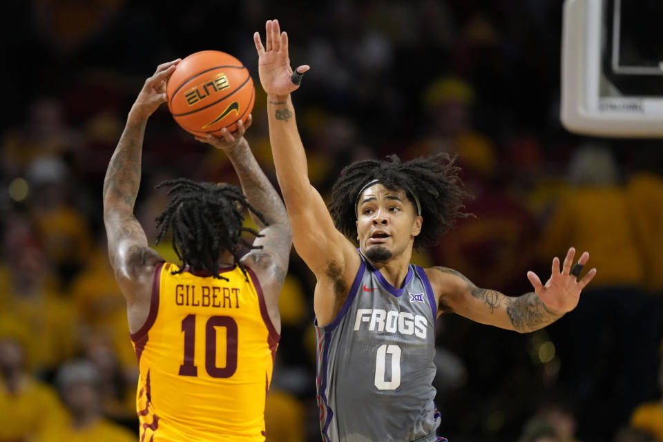 TCU guard Micah Peavy (0) looks to block a shot by Iowa State guard Keshon Gilbert (10) during the first half of an NCAA college basketball game, Saturday, Feb. 10, 2024, in Ames, Iowa. (AP Photo/Charlie Neibergall)