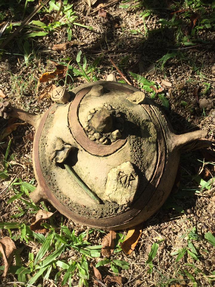 The ceramic ball has a rose and headstone that says RIP moulded onto it. 