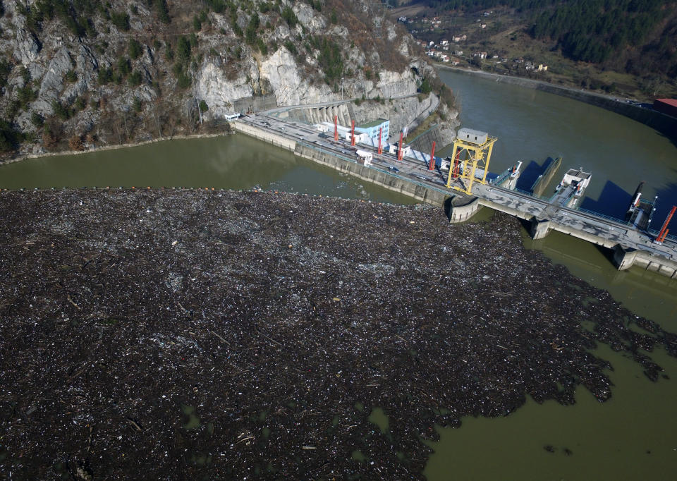 This is aerial photo shows plastic bottles, wooden planks, rusty barrels and other garbage clogging the Drina river near the eastern Bosnian town of Visegrad, Bosnia, Tuesday, Jan. 5, 2021. Further upstream, the Drina tributaries in Montenegro, Serbia and Bosnia are carrying even more waste after the swollen rivers surged over the the landfills by their banks. The Balkan nations have poor waste management and tons of garbage routinely end up in rivers. (AP Photo/Eldar Emric)