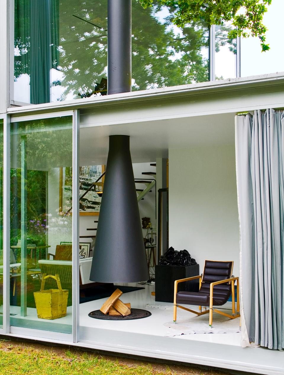 A Transat sits fireside in this Belgian pavilion, built by the architect Maarten Van Severen.