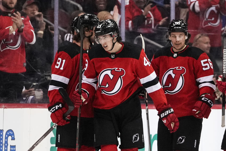 New Jersey Devils' Luke Hughes (43) celebrates with Dawson Mercer (91) and Erik Haula (56) after scoring a goal against the New York Rangers during the first period of an NHL preseason hockey game Wednesday, Oct. 4, 2023, in Newark, N.J. (AP Photo/Frank Franklin II)