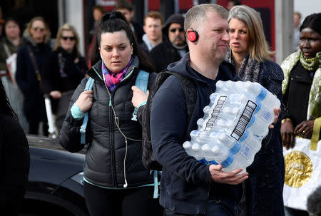 Local residents collect bottled water distributed by Thames Water after mains supplies to homes were cut off following bad weather, in Balham, south London, March 5, 2018. REUTERS/Toby Melville