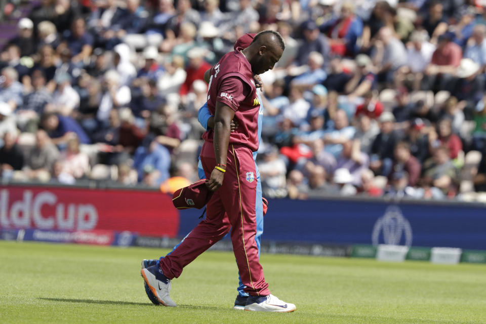 West Indies' Andre Russell walks off the field of play with an injury after bowling during the Cricket World Cup match between England and West Indies at the Hampshire Bowl in Southampton, England, Friday, June 14, 2019. (AP Photo/Matt Dunham)