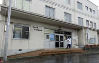 <p>A police officer stands guard in front of the Tsukui police station where a murder suspect is being held for a knife attack at a disabled persons facility outside Tokyo, Japan, Tuesday, July 26, 2016. (AP Photo/Mari Yamaguchi)</p>